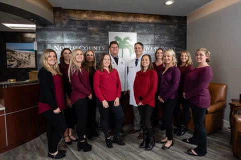 Team photo of dentists and staff at North County Cosmetic and Implant Dentistry in Vista, CA