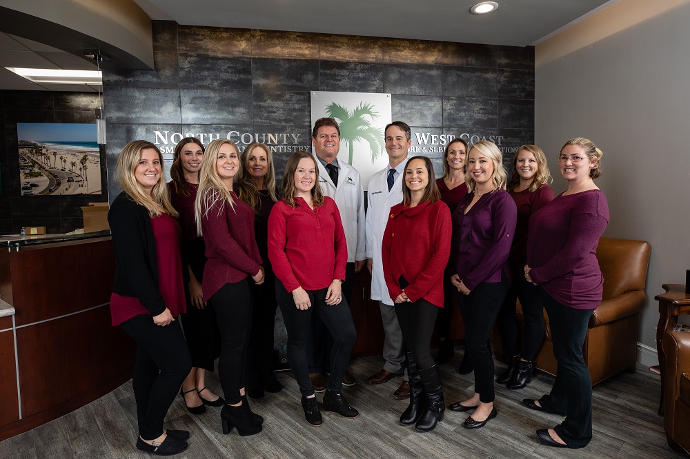 Team photo of dentists and staff at North County Cosmetic and Implant Dentistry in Vista, CA