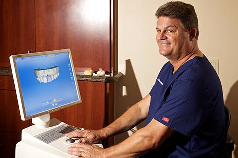 Cosmetic dentist in Vista, CA reviewing 3D teeth model on screen at North County Cosmetic and Implant Dentistry