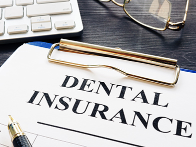 Dental insurance form on clipboard at North County Cosmetic and Implant Dentistry in Vista, CA