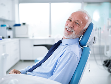 Older man in shirt and tie ready for new patient dental exam at North County Cosmetic and Implant Dentistry in Vista, CA